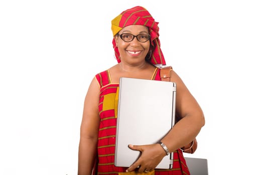 mature businesswoman standing on white background smiling with laptop in hand.