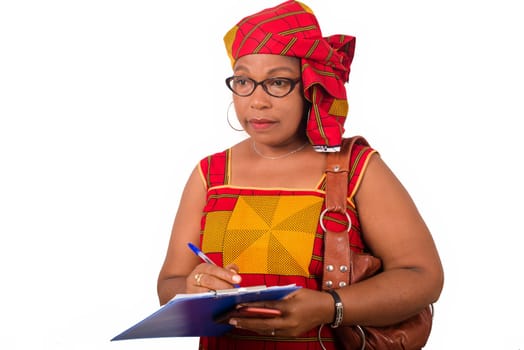 mature businesswoman standing on white background writing on a notepad.