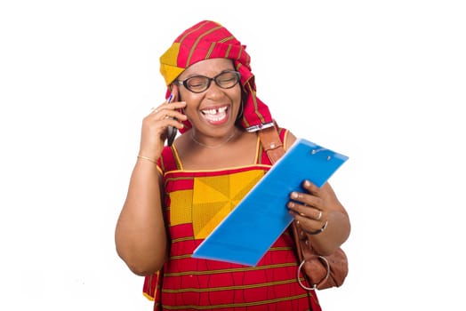 mature businesswoman standing on white background communicating on cellphone and looking at her notepad laughing.