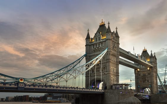 London, UK - Feb 15, 2024 - Beautiful scenery view of famous Tower bridge and skyline with reflections in the river thames just after sunset. The illuminated Tower Bridge, Space for text, Selective focus.