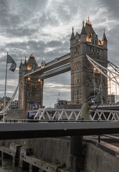 London, UK - Feb 15, 2024 - Beautiful scenery view of famous Tower bridge and skyline with reflections in the river thames just after sunset. The illuminated Tower Bridge, Space for text, Selective focus.