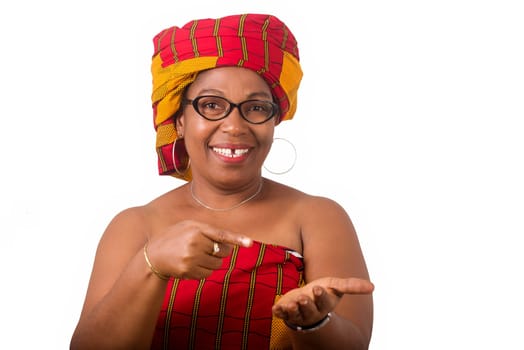 mature woman in glasses standing on white background gesturing and looking at camera smiling.