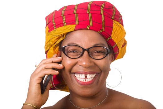 mature woman in glasses standing on white background communicating on cell phone laughing.