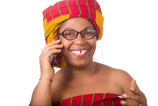 mature woman in glasses standing on white background communicating on cell phone laughing.