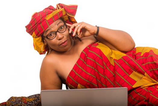 mature woman on white background communicating on cellphone while looking at camera.