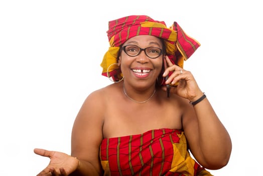 mature woman on white background communicating on cellphone and looking at camera laughing.