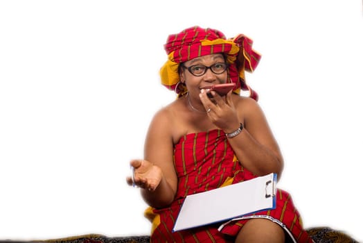 mature woman in loincloth sitting on the floor hand to communicate on mobile phone smiling.