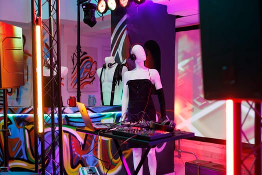 Musician sound mixer and mannequin in headset on stage in dark nightclub with spotlights. Dj controller equipment prepared for live performance and discotheque party in club