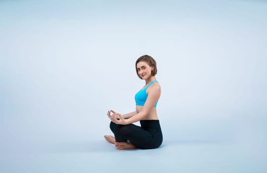 Full body length gaiety shot athletic and sporty woman doing healthy and meditative yoga exercise workout posture on isolated background. Healthy active and body care lifestyle