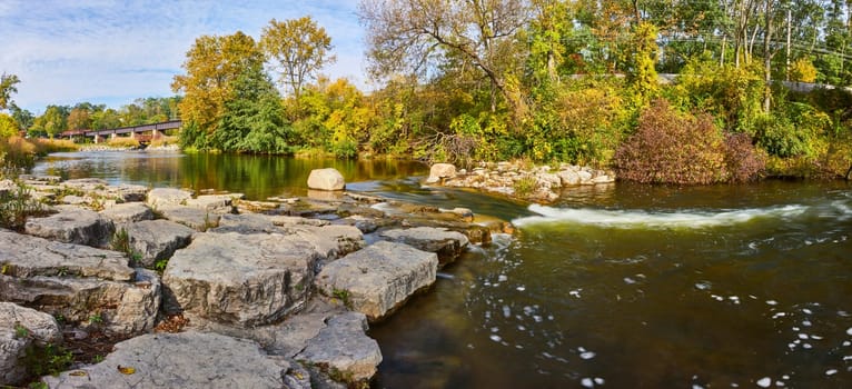 Serene Fall Morning at Huron River, Michigan, Featuring Rustic Covered Bridge and Rocky Waterfall