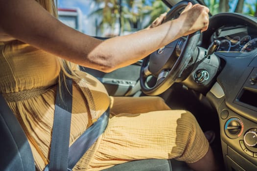 Pregnant woman driving with safety belt on in the car. Confident and capable, a pregnant woman takes the wheel, driving with care and determination as she navigates the journey of motherhood.