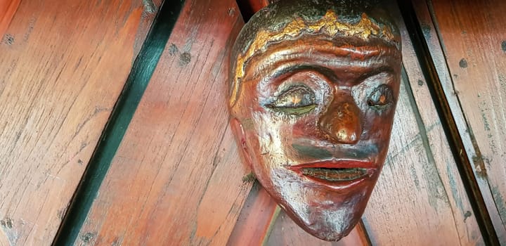 Mystical wooden mask and artworks in traditional retro Javanese style contains spirit of the dead