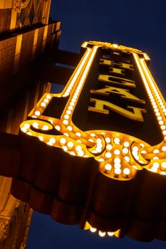 Vintage marquee of Michigan Theater in downtown Ann Arbor glowing against the evening sky, encapsulating the nostalgia of the golden age of cinema.