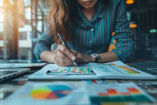 Selective focus on the businesswoman's hand, writing down tasks and note, office background.