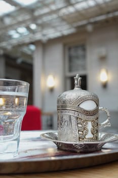 a cup of turkish coffee on table .