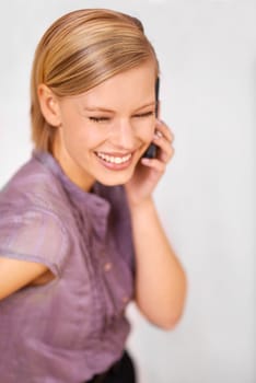 Woman, cellphone call and smile in office with communication for contact, thinking or deal at startup agency. Person, employee and mobile phone for conversation, negotiation or listening in workplace.