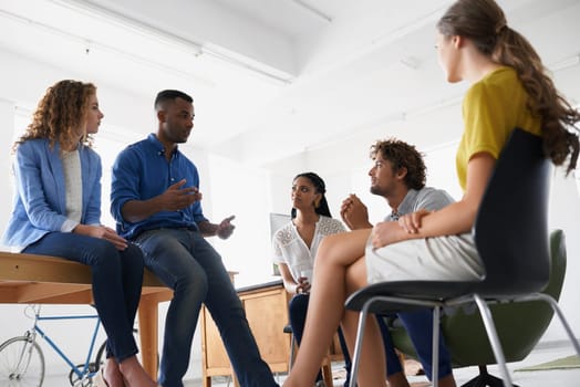 Low angle of creative people, meeting and discussion at startup with planning and team. diversity and communication for project management. Ideas, notes and strategy with collaboration at agency.