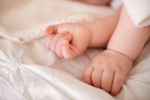 Baby, hands and fingers on bed as closeup for childhood development or nursery sleeping, relax or resting. Kid, wellness and childcare in home for wellbeing nap or dreaming nurture, caring or calm.