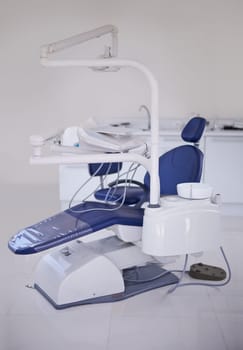 Dental, chair and healthcare at dentist office, medical equipment or furniture for oral health and wellness. Orthodontics, dentistry and treatment workspace for mouth care at orthodontist clinic.