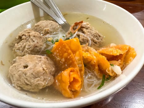 super delicious, tender and juicy and spicy bites of beef tendon meatballs in a bowl in Indonesian street food
