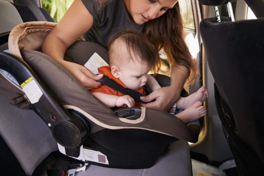 Mom, baby and car seat in motor vehicle for child safety with buckle or strap. Mother, infant and protection, travel and parenting for secure transport to fasten or latch with love and harness.