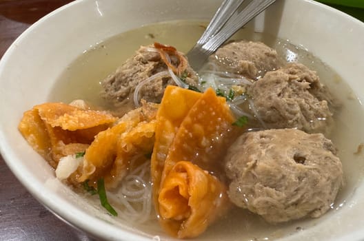 super delicious, tender and juicy and spicy bites of beef tendon meatballs in a bowl in Indonesian street food