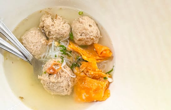 super delicious, tender and juicy and spicy bites of beef tendon meatballs in a bowl in Indonesian street food