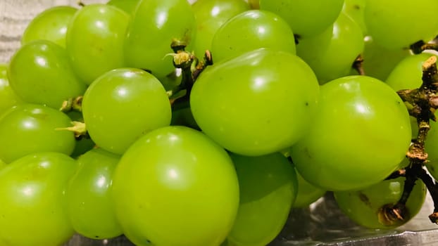 seedless green Shine Muscat grape background in a container. Japanese grapes. white grapes local produce