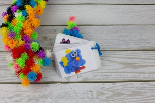 Example of creating bird toy from sticky construction set with hooks, multi colored burdock balls