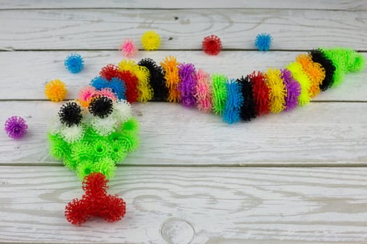 Snake made of viscous fluffy balls, multi colored burdock toy with hooks