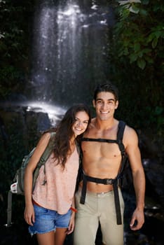 Hiking, waterfall or portrait of happy couple in nature for journey on outdoor trekking adventure. Man, woman or people on holiday vacation to relax in shade or woods for exercise, travel or wellness.