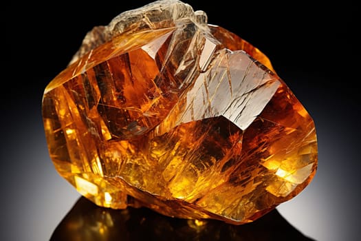 Large stone of yellow citrine and amber on a dark background.