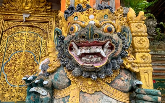 Traditional old ancient Balinese statue of demon angel called barong bali guarding sacred ritual temple of hiduism