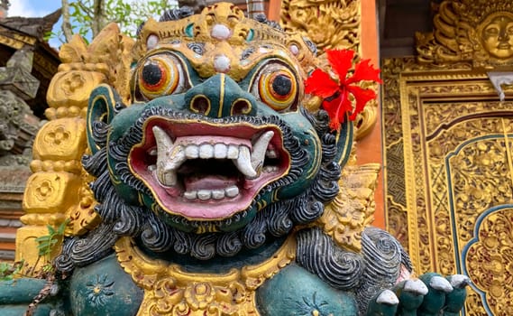 Traditional old ancient Balinese statue of demon angel called barong bali guarding sacred ritual temple of hiduism