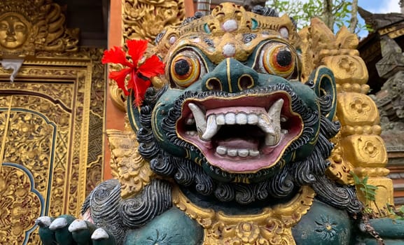 Traditional old ancient Balinese statue of demon angel called barong bali guarding sacred ritual temple of hiduism