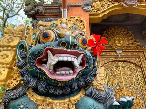 Traditional old ancient Balinese statue of demon angel called barong bali guarding sacred ritual temple of hiduism