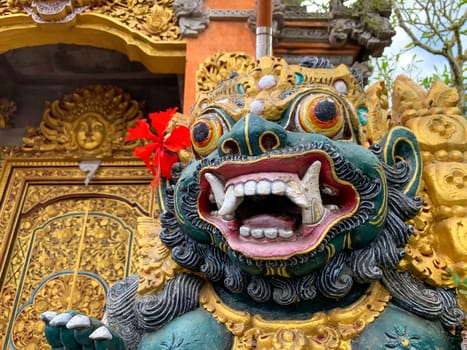 Traditional old ancient Balinese statue of demon angel called barong bali guarding sacred ritual temple of hiduism