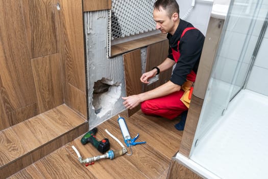 Plumber working in the bathroom. High quality photo