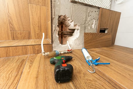 hole into the inside wall and heating pipes . High quality photo