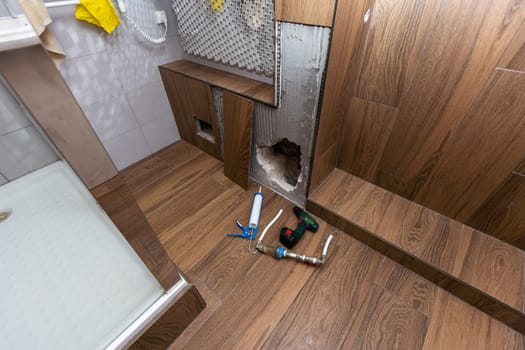 hole into the inside wall and heating pipes . High quality photo