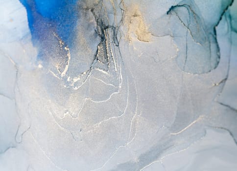 Abstract art with blue and gold background, beautiful smudges and stains made with alcohol ink. Abstract painting, background for wallpapers, posters, cards, invitations, websites.