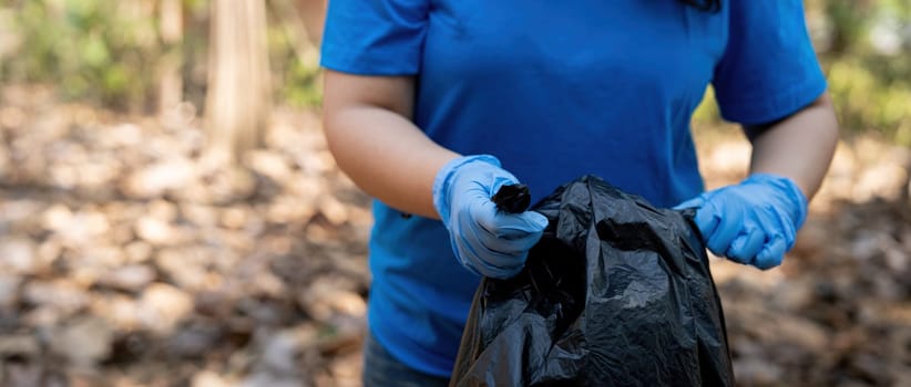 Separating waste to freshen the problem of environmental pollution and global warming, plastic waste, care for nature. Volunteer concept carrying garbage bags collecting the garbage.