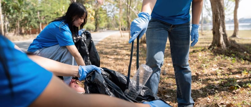 Volunteer collecting plastic trash in the forest. The concept of environmental conservation. Global environmental pollution. Cleaning the forest.