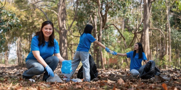 Volunteer collecting plastic trash in the forest. The concept of environmental conservation. Global environmental pollution. Cleaning the forest.