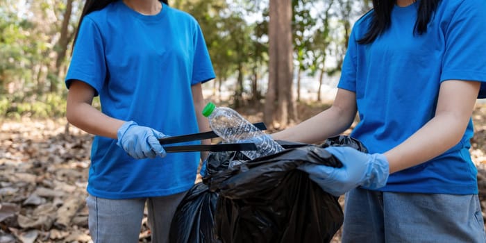 Volunteer collecting plastic trash in the forest. The concept of environmental conservation. Global environmental pollution. Cleaning the forest.