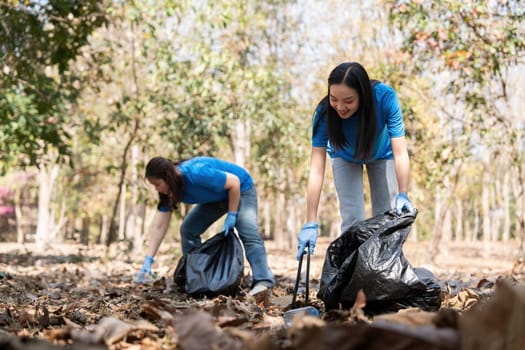 Volunteer collecting plastic trash in the forest. The concept of environmental conservation. Global environmental pollution. Cleaning the forest.