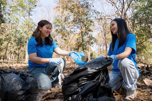 Volunteer collecting plastic trash in the forest. The concept of environmental conservation. Global environmental pollution. Cleaning the forest.