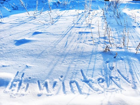 Inscription Hi Winter, written on white background of the snow. Top view. Flat lay. New year and Christmas