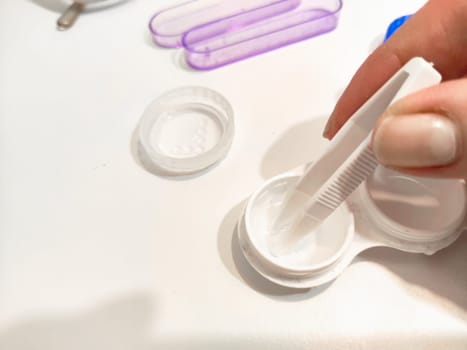 Set for contact lenses with a container, forceps, glasses. The concept of correcting myopia. Contact lens care, cleaning, health. Background, copy space