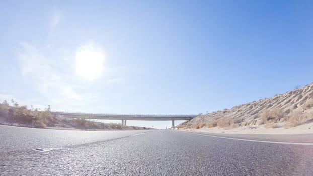 Embarking on a road trip from Nevada to California, driving on Highway 15 during the day offers scenic views and an exciting journey between states.